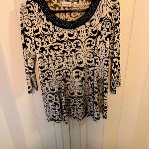 White and black dressy top. Border around neckline   Polyester/rayon.